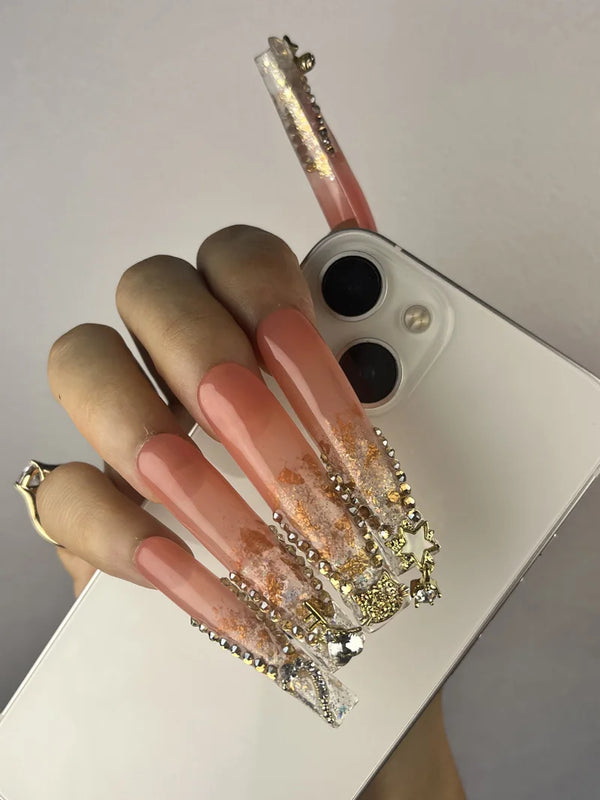 Match nails long French tip pink glitter nails in one hand with a mobile phone