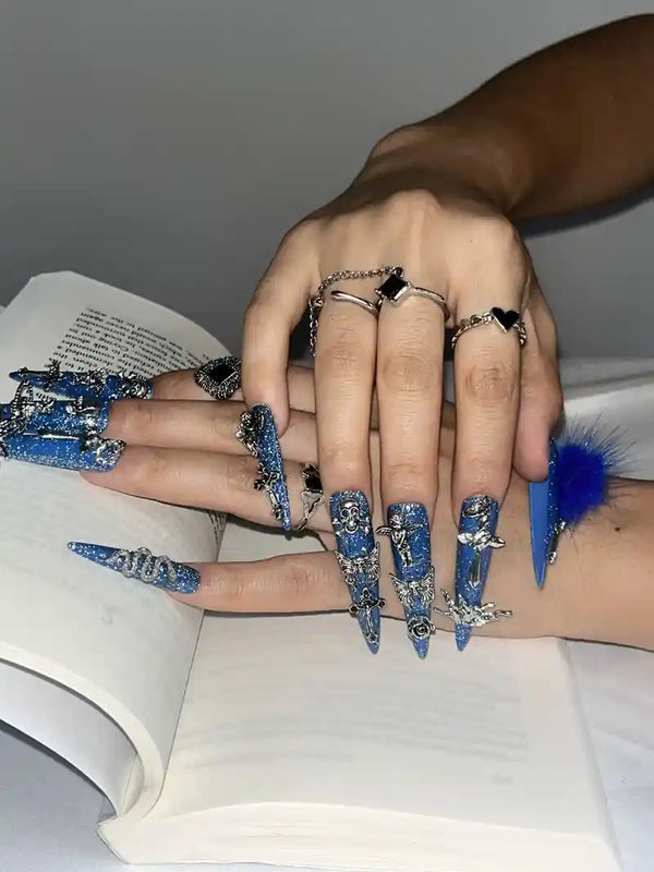 Match nails long stiletto cross blue nails on a book