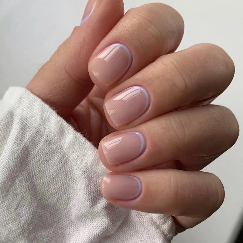 Match Nails Perfectly Poised: Short round nude press-on nails with a touch of playful purple edge.