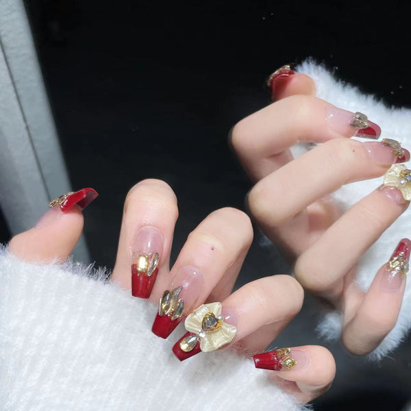 Effortless New Year's Eve glam! Rose red French tip luxury coffin press-on nails for a touch of opulence.